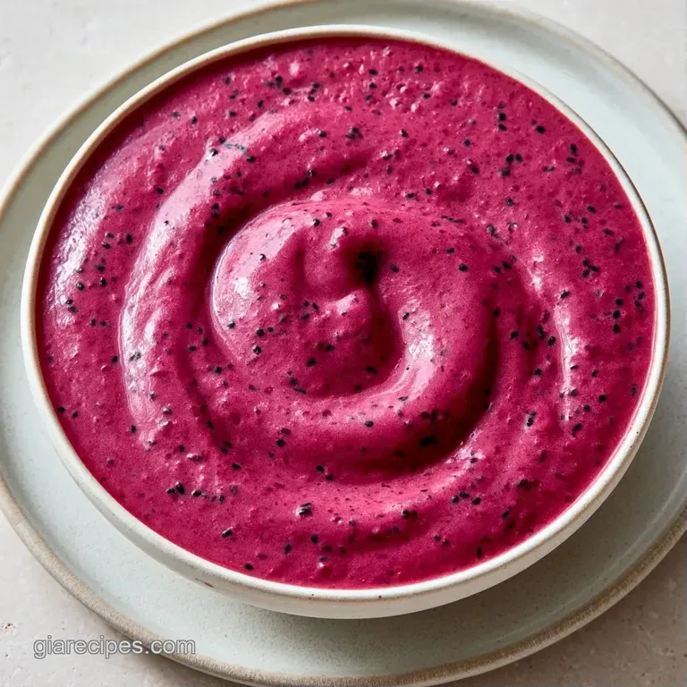 A chilled glass of deep violet smoothie with a striped straw, set against a bright, airy morning kitchen backdrop.