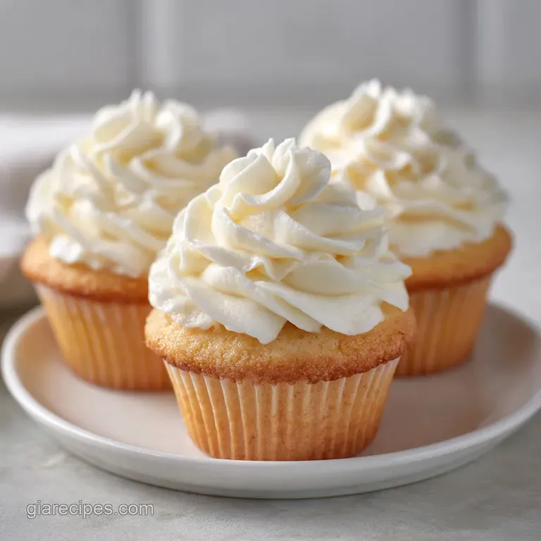 Golden cupcakes arranged on a white porcelain plate with a linen napkin and a small silver dessert fork.