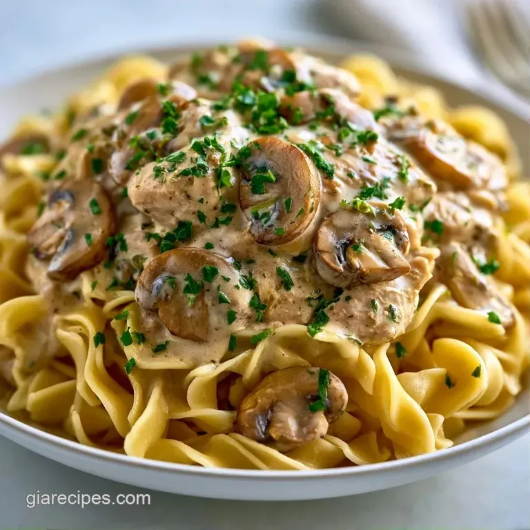 Elegant white bowl of creamy mushroom sauce and tender turkey, garnished with a sprinkle of fresh chopped parsley.