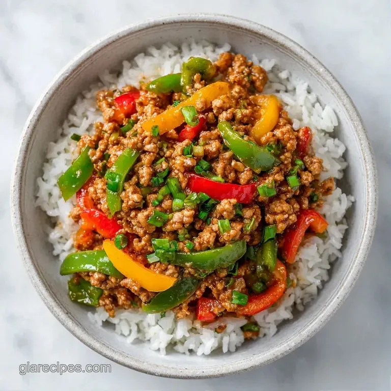 Colorful medley of browned ground turkey and saut&eacute;ed peppers served in a white ceramic bowl with fresh parsley.
