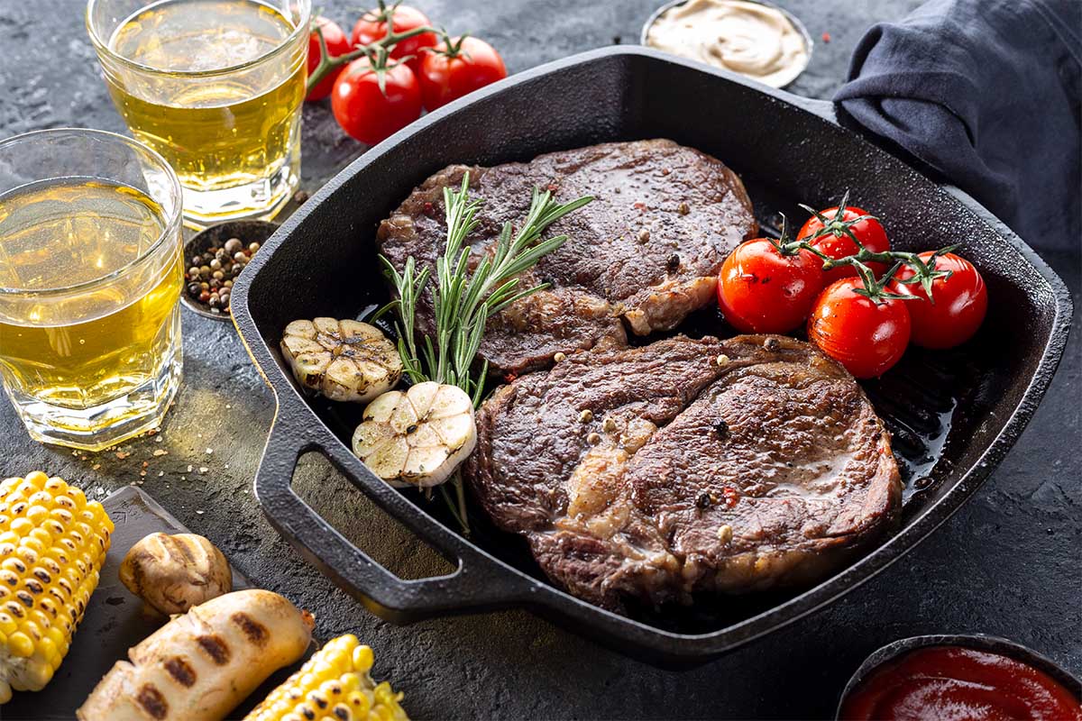 Slow-cooked cube steak in a crock pot with gravy and vegetables