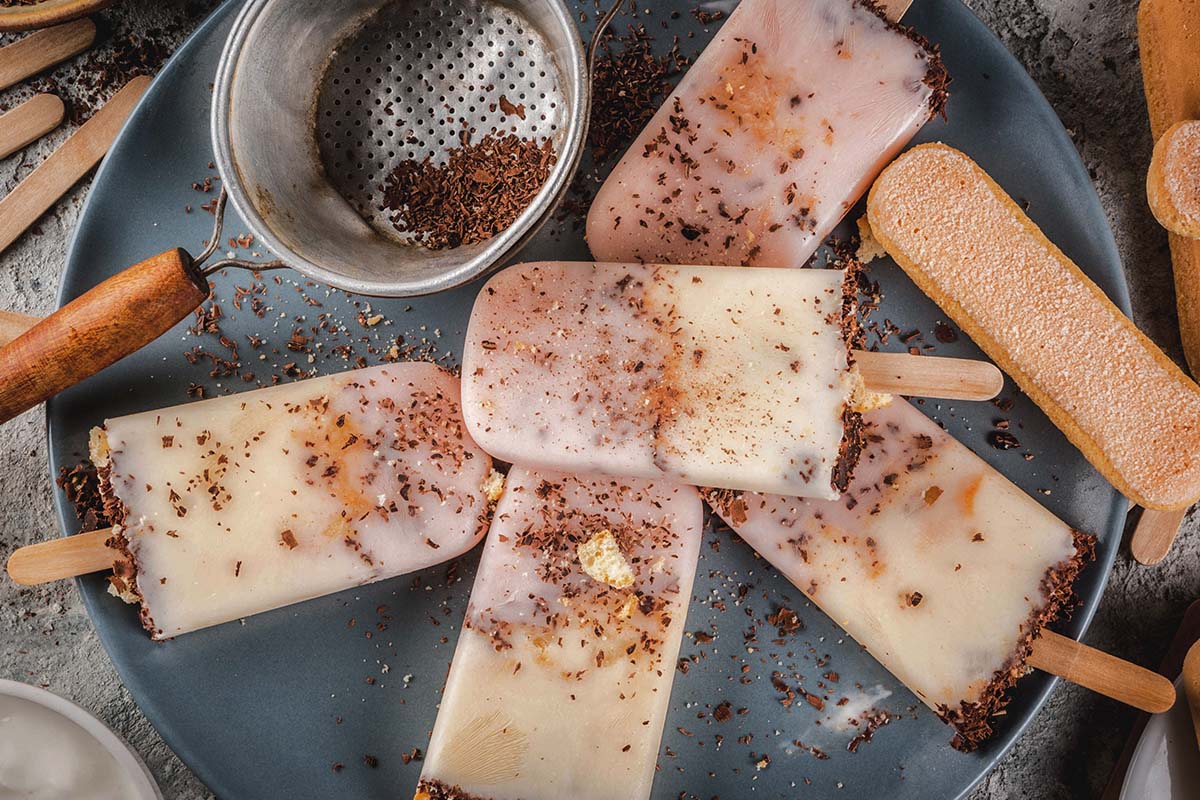 Delicious homemade Eskimo Pie popsicles with a chocolate coating, served on a plate with sprinkles