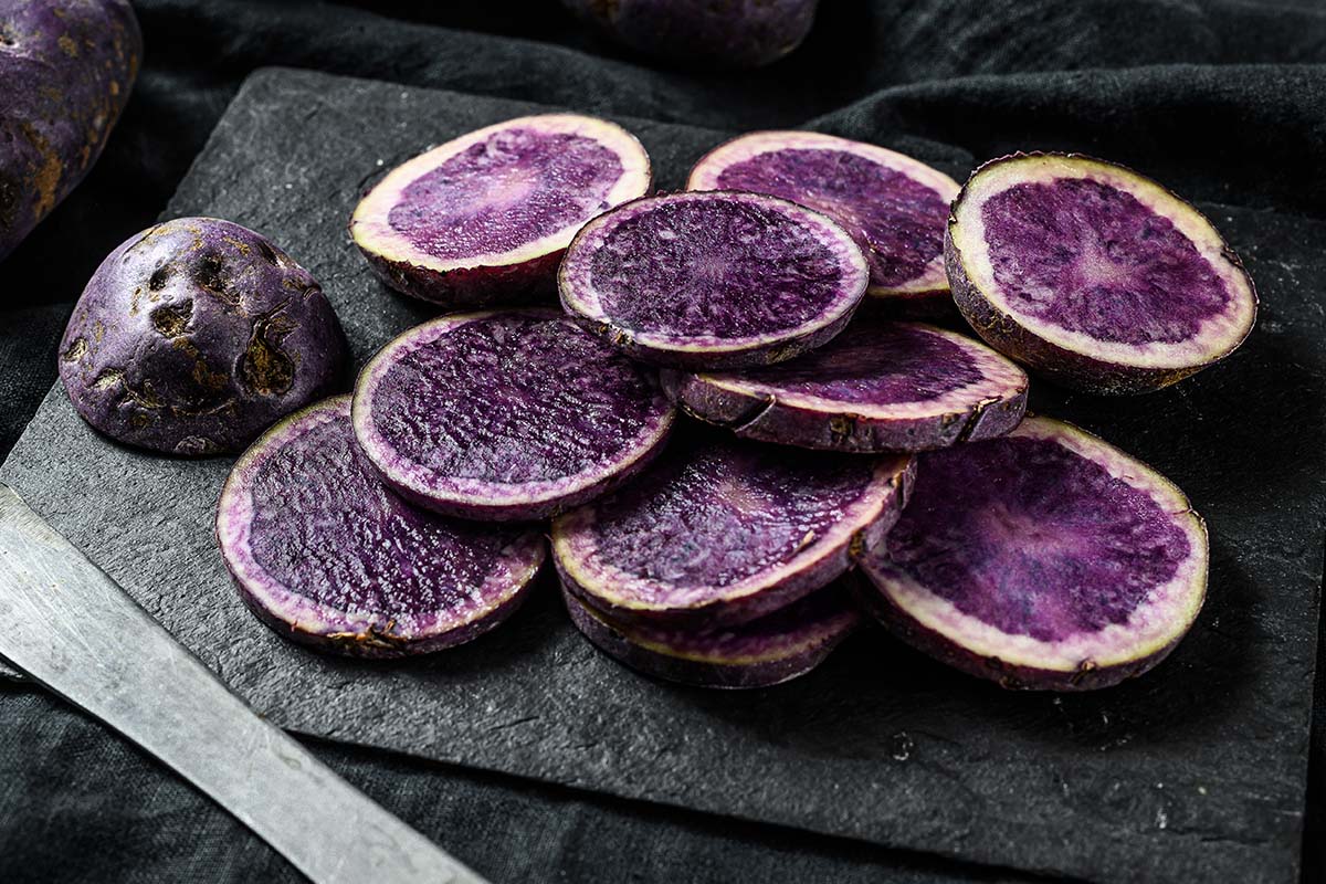 A vibrant plate of purple sweet potatoes showcasing their rich color and health benefits