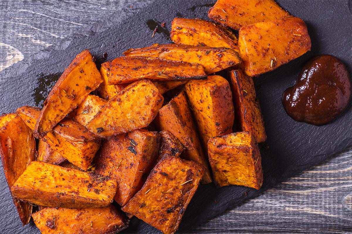 Crispy sweet potato fries in air fryer basket