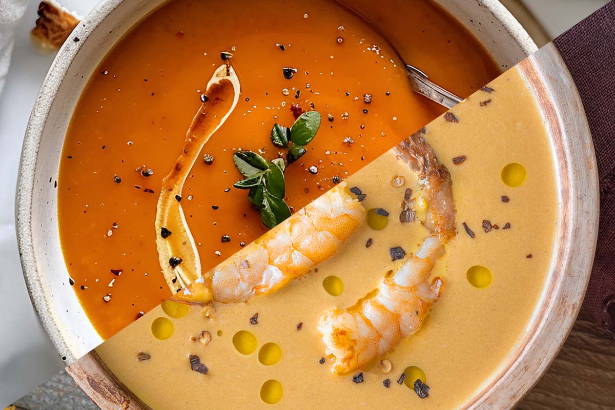 Bowl of rich creamy bisque soup garnished with herbs.