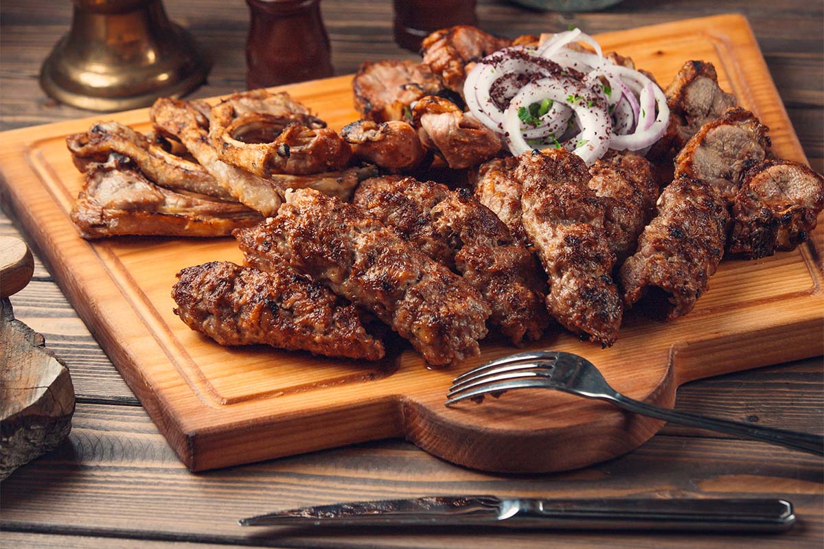 Smoked meat prepared using smoker recipes on a grill