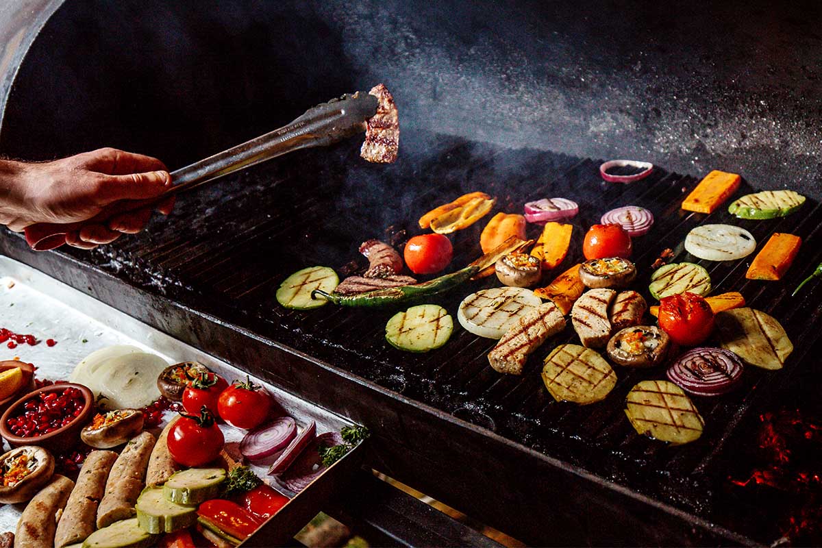 Delicious smoked brisket with vegetables are some of the best foods cooked in a smoker.